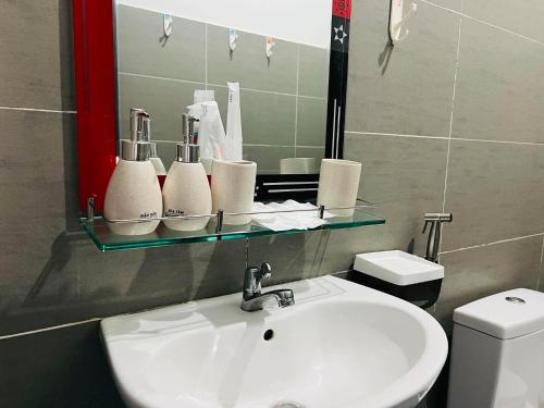 a bathroom with a sink and a mirror at KyNa House in Rạch Giá