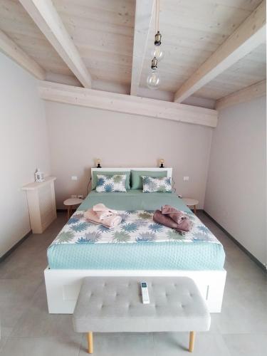 a bedroom with a large bed with a wooden ceiling at Casa Mario in San Severo