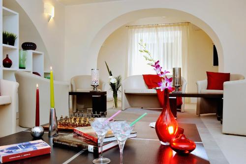 a living room with red vases on a table at Demetra Hotel in Rome
