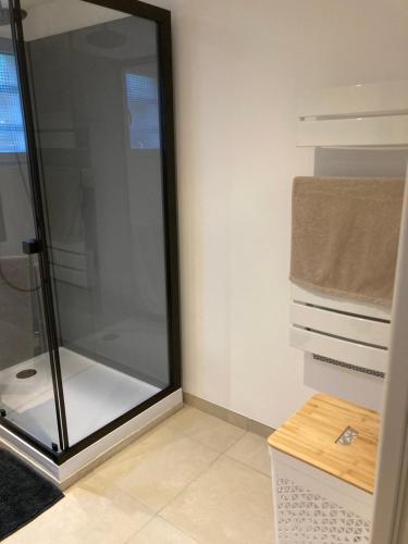 a shower with a glass door in a bathroom at Au Petit Paradis in Balan