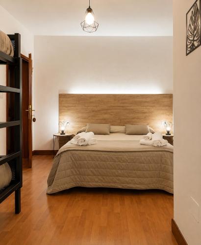 a bedroom with a large bed with two towels on it at Albergo Ristorante Lo Scoiattolo in Campigna