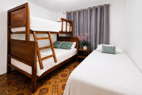 a bedroom with two bunk beds and a window at Villa Aurora 3 Bedroom 2 Baths in Baños