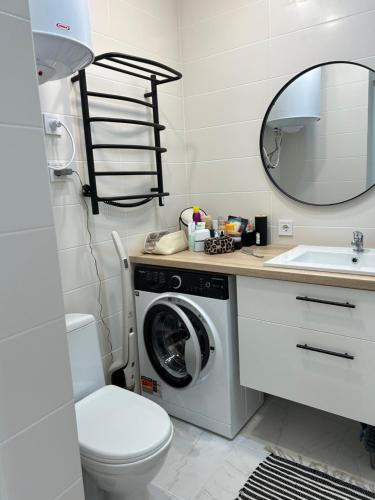 a bathroom with a washing machine and a sink at Смарт хаус in Yuzhne