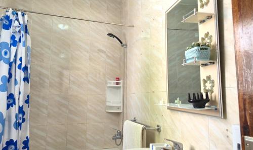a bathroom with a shower and a sink and a mirror at Indigo House in Chefchaouen