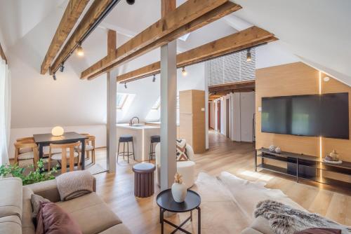 a living room with a couch and a tv and a table at Apartmány Ski Telgárt - Telgárt Resort in Telgárt