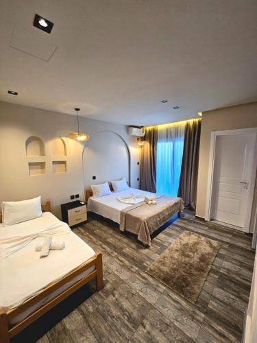 a hotel room with two beds and a window at Casa Lu in Ulcinj
