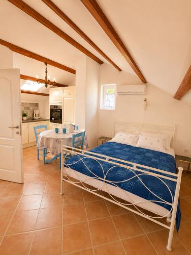 a bedroom with a bed and a table in a room at Studio Apartman Blue Sky in Senj