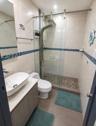 a bathroom with a shower and a toilet and a sink at Private Island Oceanview Condo in Fajardo