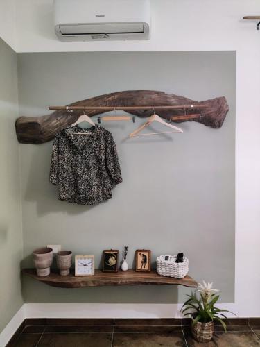a shelf in a room with a shirt and pictures at Palazzo ReSilente- B&B dell'Infopoint in Castelnuovo Cilento