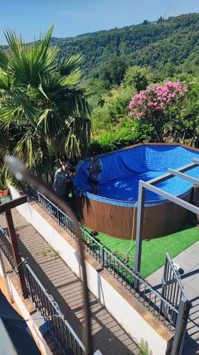 a view of a swimming pool from the balcony of a house at Casa Malù in SantʼAlfio