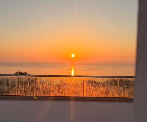 a view of a sunset from a window at Dar Carthage Hergla in Harqalah