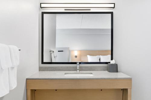 a bathroom with a sink and a mirror at Hyatt Place College Station in College Station