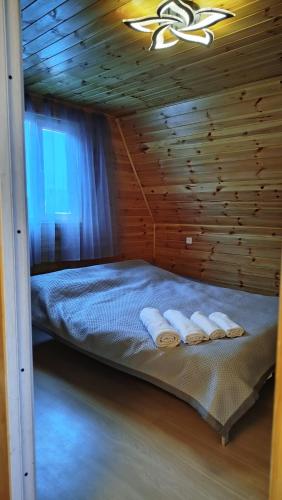 a bedroom with a bed with two towels on it at Тайыз Кол in Tossor