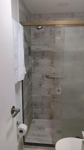 a bathroom with a shower with a glass door at We Rent VIP - San Julián in Medellín