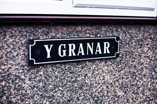 a sign that says y grandar on a wall at Granary at Tyddyn Isaf in Ruthin