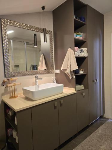 a bathroom with a sink and a mirror at Sea View Apartment in Bijela