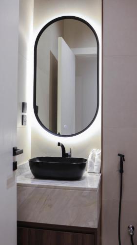 a bathroom with a black sink and a mirror at V Beach in Jeddah