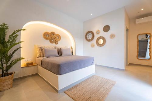 a bedroom with a bed with an arch above it at IOSIF hideaway in Neos Marmaras