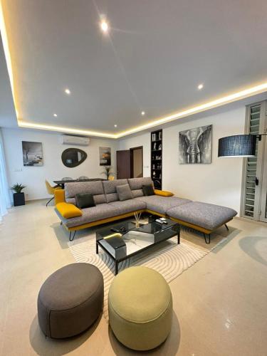 a large living room with a couch and a table at Antilia home 1 in Abidjan