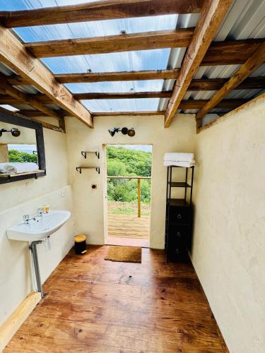a bathroom with a sink and a window at Les Coumayres in Riols