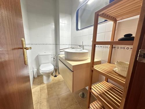 a bathroom with a sink and a toilet at Los Pescadores Playa Sol in Novo Sancti Petri