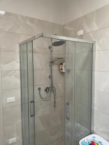 a shower with a glass door in a bathroom at La Volta di Chiara in Roccaforzata