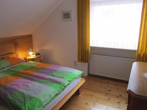 a bedroom with a bed and a large window at Fewo Glaser in Lug