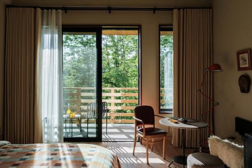 a bedroom with a bed and a room with a balcony at New Paltz Way Hotel in New Paltz