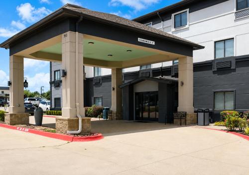 a building with a large entrance to a building at Grander Inn & Suites by IHG in Tyler