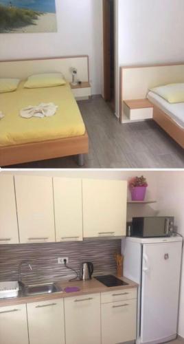 a small kitchen with a bed and a refrigerator at Nadalina 9 in Starigrad