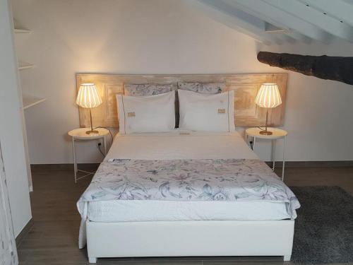 a bedroom with a large bed with two lamps at Islet House in São Roque