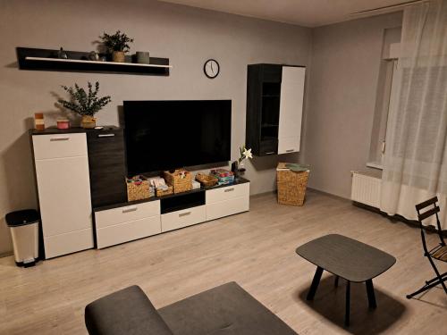 a living room with a large flat screen tv at By the Center in Balatonalmádi