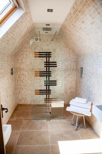 a bathroom with a shower with a towel rack at The Harcourt Arms in Witney