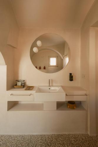 a bathroom with a white sink and a mirror at Sant'Angelo Ostuni - Il Palazzo in Ostuni