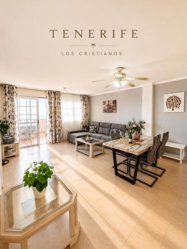 a living room with a table and a couch at Best Ocean View & Sunset - Los Cristianos in Los Cristianos