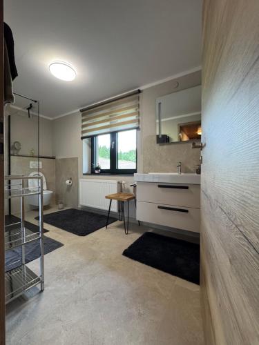 a large bathroom with a sink and a mirror at Haus Asslaber in Hochfilzen