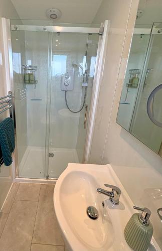 a bathroom with a sink and a shower at Minch View Cabin 2, 1 Earlish in Earlish