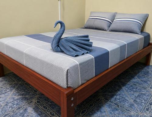 a bed with a blue swan on top of it at Amazon City House Iquitos in Iquitos