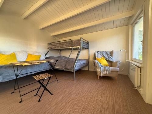 a room with two bunk beds and a couch at Rävboet in Österbi