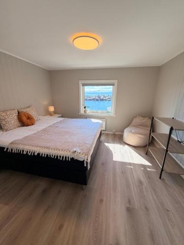 a bedroom with a large bed and a window at Reine Viewpoint House in Reine
