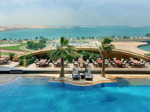 a view of a swimming pool at a resort at Sofitel Abu Dhabi Corniche in Abu Dhabi