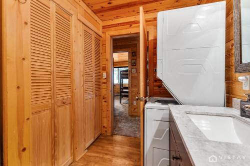 a kitchen with a stove and a white appliance at Lovely Log Cabin With Fire Pit! in Duck Creek Village