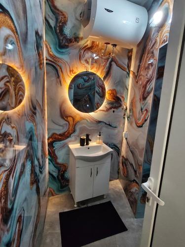a bathroom with a painting on the wall at Studio 714 in Škaljari