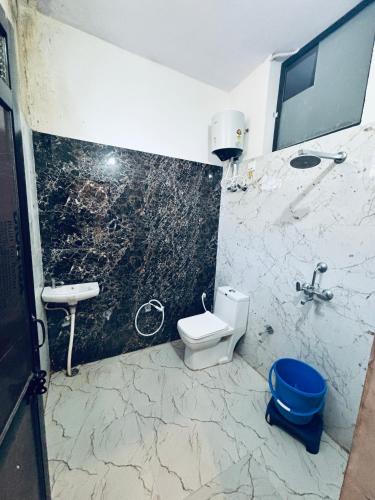 a bathroom with a toilet and a sink at Barsana Geust House in Khātu