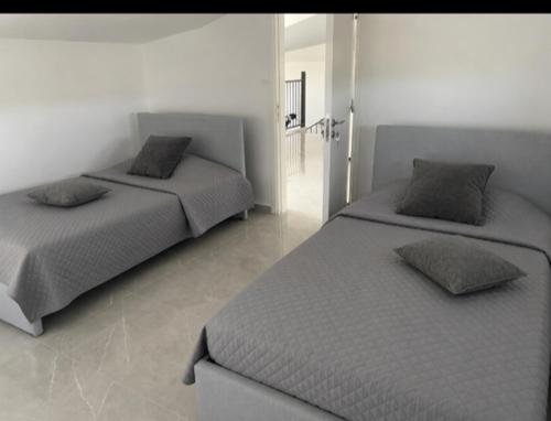 a bedroom with two beds with pillows on them at Olivia Suite in Pano Arodes