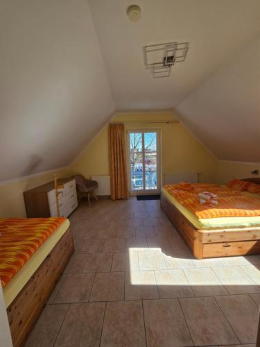 a bedroom with two beds and a window at Ferienresidenz Am Strom in Warnemünde