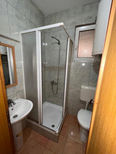 a bathroom with a shower and a toilet and a sink at M apartment in Ohrid