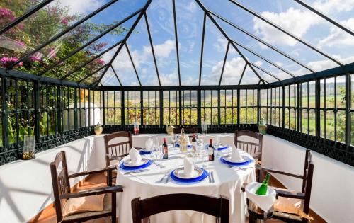 una sala da pranzo con tavolo in una casa di vetro di Hacienda el Santiscal ad Arcos de la Frontera