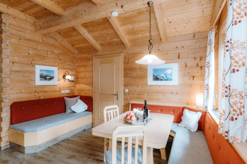 a living room with a couch and a table at Appartement Seppenbauer - Seppenbauerhof, Kärnten Card inklusive, Ticket Großglockner Hochalpenstraße in Heiligenblut