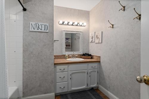 a bathroom with a sink and a mirror at Summer Fun Wenatchee home in Wenatchee